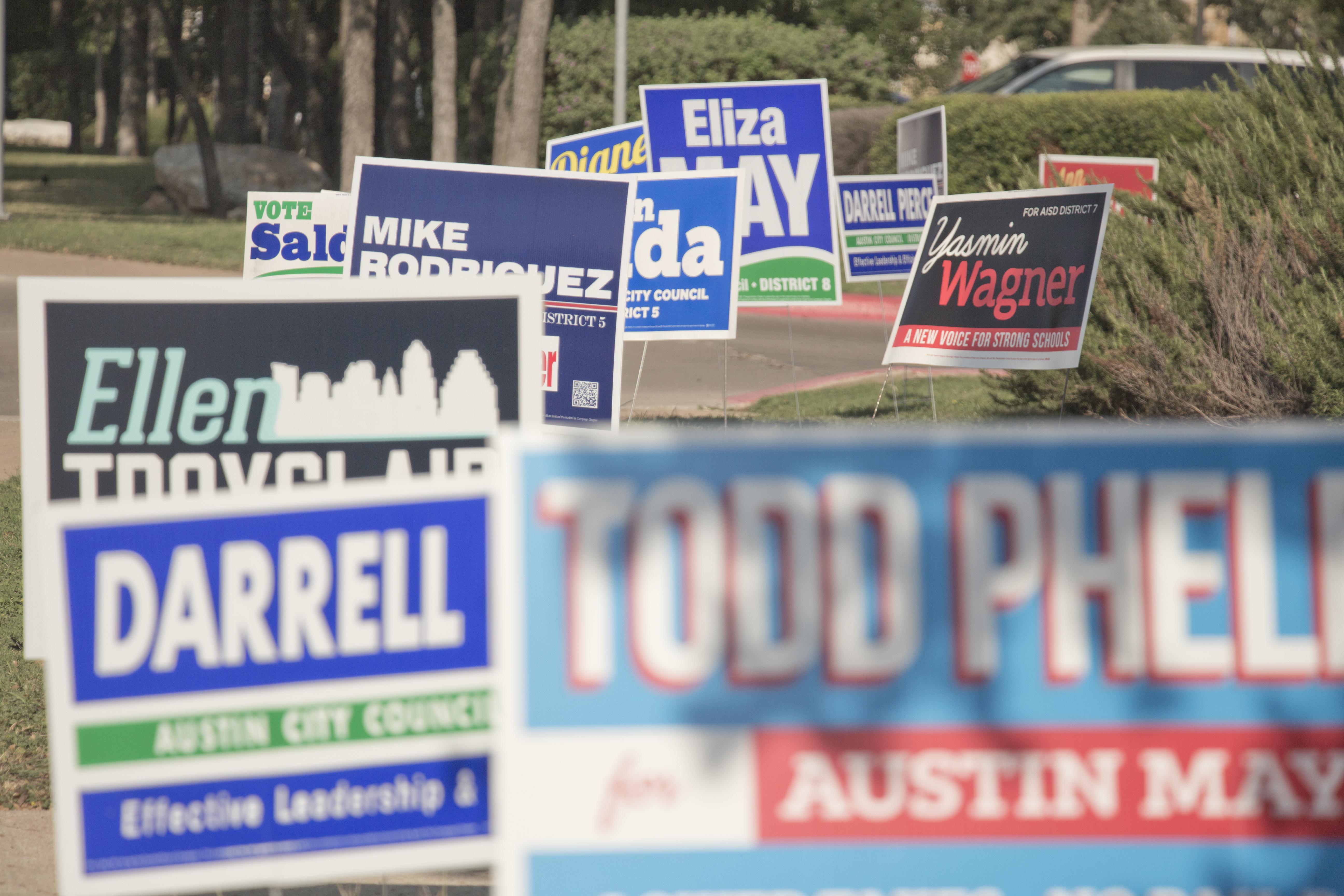 Political yard signs on a street corner in Austin, TX.