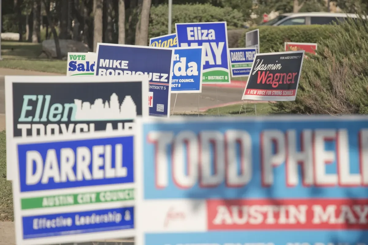 Political yard signs on a street corner in Austin, TX.